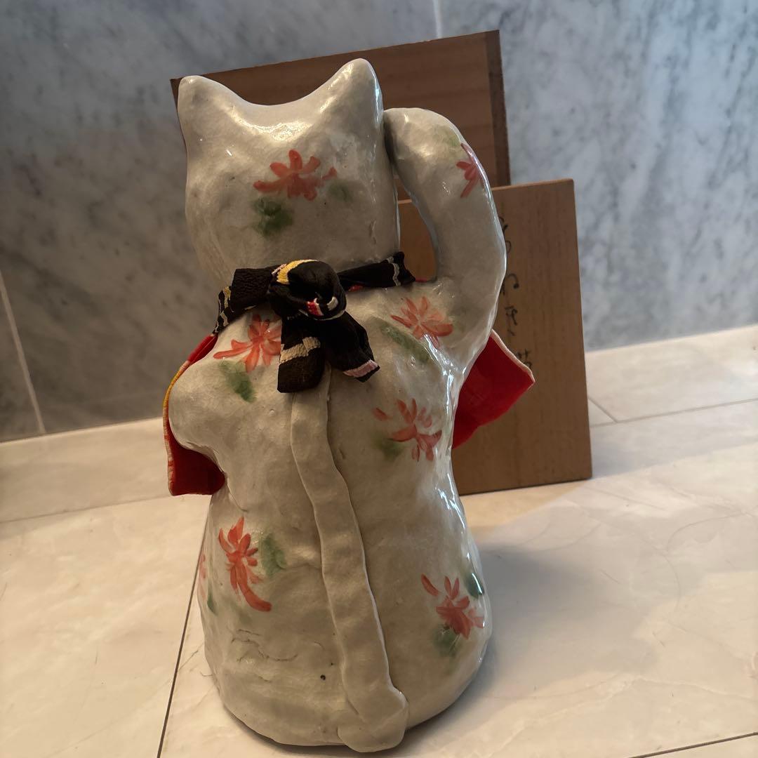 作家さんによる大きな瞳でにっこりと笑う着物の前掛けも美しい招き猫